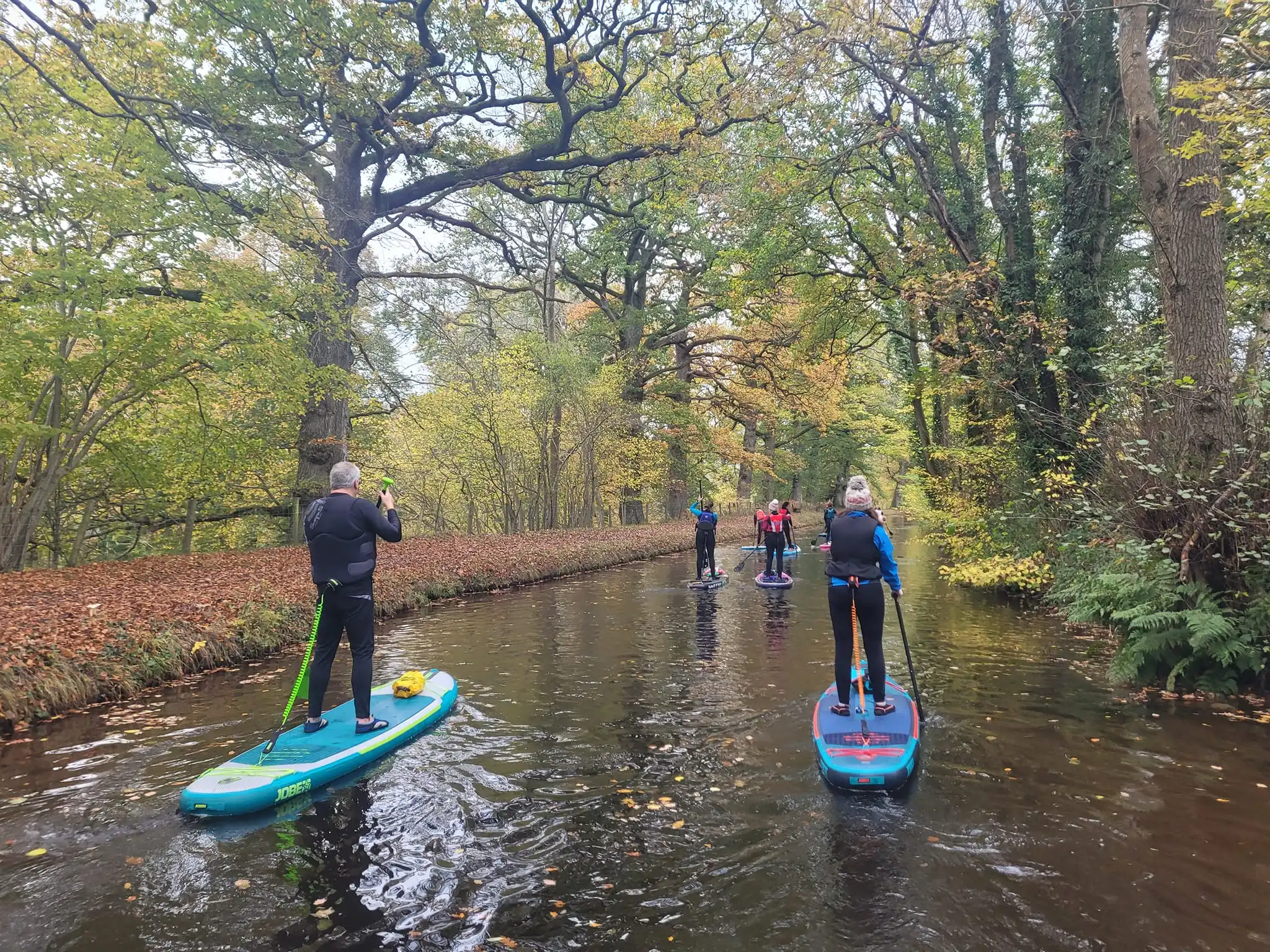Group of paddleboarders on canal