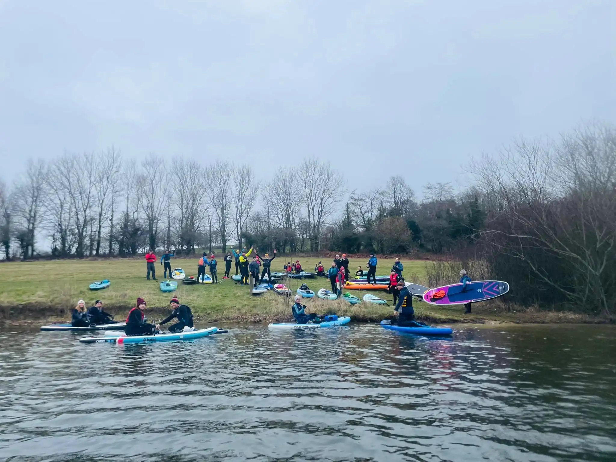 Group of paddleboarders on the bank of llandegfedd lake